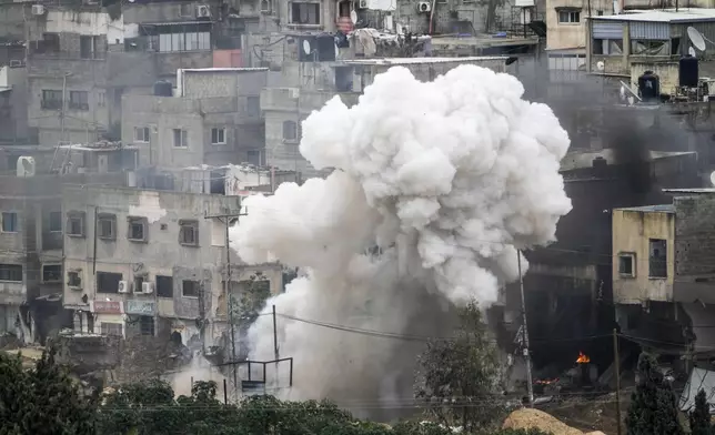 Israeli soldiers detonate an explosive device during a military raid in the West Bank refugee camp of Nur Shams, Tulkarem, Sunday, Feb. 9, 2025. (AP Photo/Majdi Mohammed)