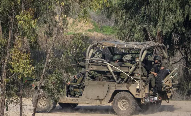 FILE - Israeli soldiers drive near the northern Gaza Strip border in southern Israel, Tuesday, Jan. 28, 2025. (AP Photo/Ariel Schalit, File)