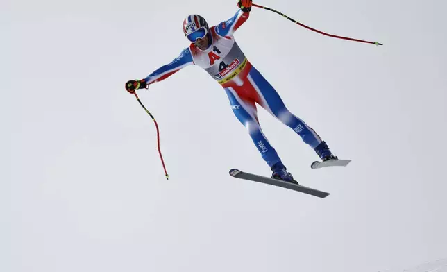 France's Adrien Theaux is airborne during a men's downhill race, at the Alpine Ski World Championships, in Saalbach-Hinterglemm, Austria, Sunday, Feb. 9, 2025. (AP Photo/Gabriele Facciotti)