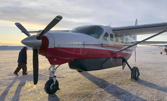 FILE - This Jan. 18, 2020, photo shows people preparing to get on an airplane at the airport in Bethel, Alaska, for a flight to Toksook Bay. (AP Photo/Mark Thiessen, File)