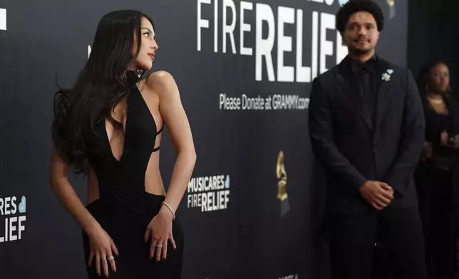 Olivia Rodrigo, left, and Trevor Noah arrive at the 67th annual Grammy Awards on Sunday, Feb. 2, 2025, in Los Angeles. (Photo by Jordan Strauss/Invision/AP)