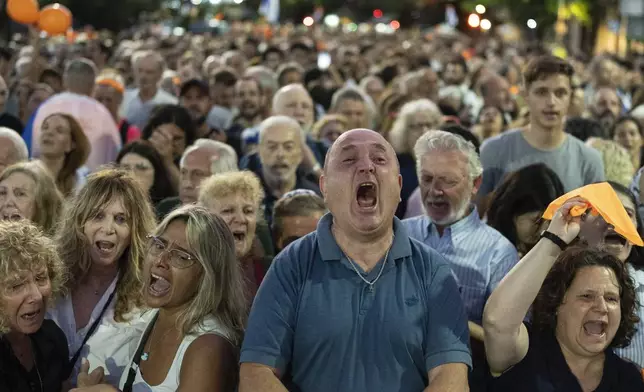 Members of the Jewish community sing the Israeli anthem while gathering in support of relatives of the hostages and victims of the October 7 massacre and to demand Hamas release the remaining hostages, in Buenos Aires, Argentina, Monday, Feb. 24, 2025. (AP Photo/Rodrigo Abd)