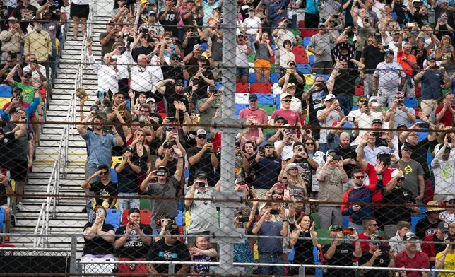 NASCAR fans watch as President Donald Trump attends the NASCAR Daytona 500 auto race at Daytona International Speedway, Sunday, Feb. 16, 2025, in Daytona Beach, Fla. (Pool via AP)