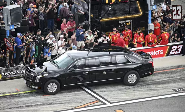 President Donald Trump rides in the presidential limousine known as "The Beast" down pit lane ahead of the start of the NASCAR Daytona 500 auto race at Daytona International Speedway, Sunday, Feb. 16, 2025, in Daytona Beach, Fla. (AP Photo/Phelan M. Ebenhack)