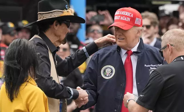 President Donald Trump, right, shakes hands with NASCAR Hall of Fame driver Richard Petty at the NASCAR Daytona 500 auto race at Daytona International Speedway, Sunday, Feb. 16, 2025, in Daytona Beach, Fla. (AP Photo/John Raoux)