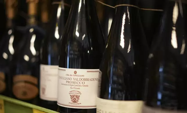 Bottles of Prosecco are lined up on a shelf of a wine shop in Rome, Thursday, Feb. 6, 2025. (AP Photo/Andrew Medichini)