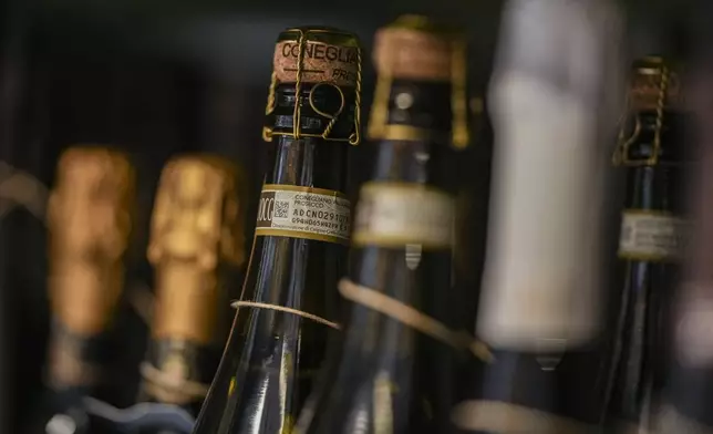 Bottles of Prosecco are lined up on a shelf of a wine shop in Rome, Thursday, Feb. 6, 2025. (AP Photo/Andrew Medichini)