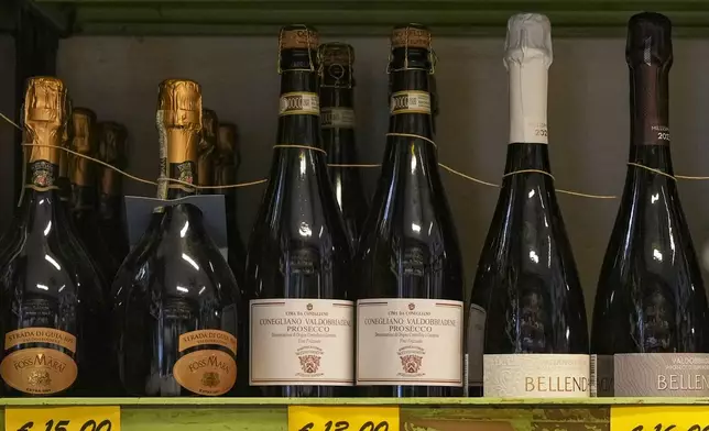 Bottles of Prosecco are lined up on a shelf of a wine shop in Rome, Thursday, Feb. 6, 2025. (AP Photo/Andrew Medichini)