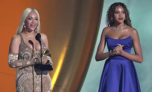 Beyonce accepts the award for album of the year for "COWBOY CARTER during the 67th annual Grammy Awards on Sunday, Feb. 2, 2025, in Los Angeles. Blue Ivy Carter looks on from right.(AP Photo/Chris Pizzello)