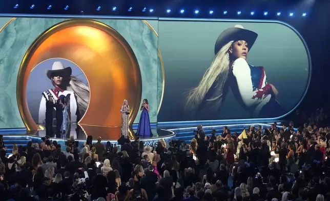 Beyonce accepts the award for album of the year for "COWBOY CARTER during the 67th annual Grammy Awards on Sunday, Feb. 2, 2025, in Los Angeles. Blue Ivy Carter looks on from right.(AP Photo/Chris Pizzello)