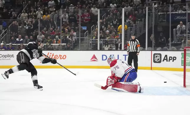 Los Angeles Kings left wing Warren Foegele, left, scores on Montreal Canadiens goaltender Jakub Dobes during a penalty shot in the second period of an NHL hockey game, Wednesday, Feb. 5, 2025, in Los Angeles. (AP Photo/Mark J. Terrill)