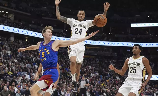 Denver Nuggets forward Hunter Tyson (5) reaches for the ball as New Orleans Pelicans guards Jordan Hawkins (24) and Trey Murphy III (25) defend in the first half of an NBA basketball game Monday, Feb. 3, 2025, in Denver. (AP Photo/David Zalubowski)