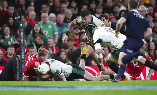 Ireland's Mack Hansen is held short of the line by Wales' Blair Murray, during the Six Nations rugby match between Wales and Ireland, at the Principality Stadium, in Cardiff, Wales, Saturday, Feb. 22, 2025. (David Davies/PA via AP)