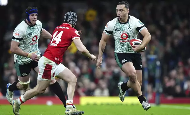 Ireland's James Lowe tackled by Wales' Tom Rogers, during the Six Nations rugby match between Wales and Ireland, at the Principality Stadium, in Cardiff, Wales, Saturday, Feb. 22, 2025. (David Davies/PA via AP)