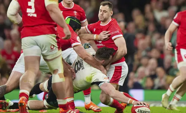 Ireland's Jack Conan scores the opening try during the Six Nations rugby match between Wales and Ireland, at the Principality Stadium, in Cardiff, Wales, Saturday, Feb. 22, 2025. (Joe Giddens/PA via AP)