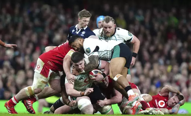 Ireland's Joe McCarthy is tackled, during the Six Nations rugby match between Wales and Ireland, at the Principality Stadium, in Cardiff, Wales, Saturday, Feb. 22, 2025. (David Davies/PA via AP)