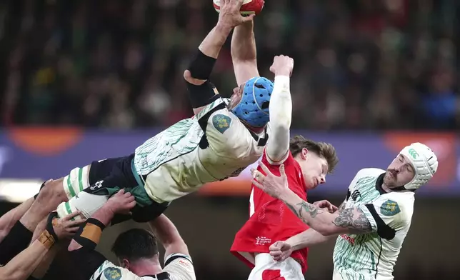 Ireland's Tadhg Beirne intercepts a high ball from Wales' Ellis Mee, during the Six Nations rugby match between Wales and Ireland, at the Principality Stadium, in Cardiff, Wales, Saturday, Feb. 22, 2025. (David Davies/PA via AP)