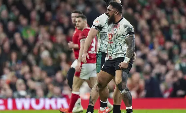 Ireland's James Lowe and Bundee Aki celebrates winning a penalty, during the Six Nations rugby match between Wales and Ireland, at the Principality Stadium, in Cardiff, Wales, Saturday, Feb. 22, 2025. (Joe Giddens/PA via AP)