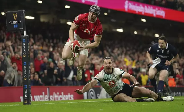 Wales' Tom Rogers scores his side's second try, during the Six Nations rugby match between Wales and Ireland, at the Principality Stadium, in Cardiff, Wales, Saturday, Feb. 22, 2025. (Joe Giddens/PA via AP)