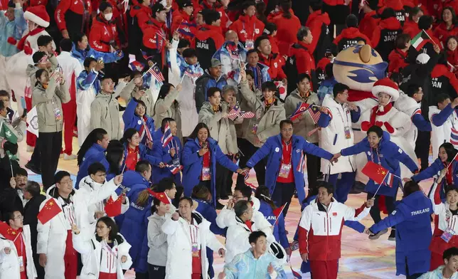 Athletes of China, Thailand, Malaysia and Japan during the closing ceremony of the Asian Games in Harbin, China, Friday, Feb. 14, 2025. (Hannah Mckay, Pool Photo via AP)