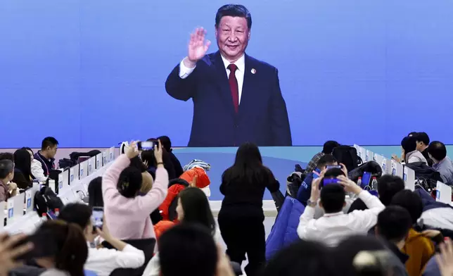 China's President Xi Jinping is seen on a screen in the media centre during the opening ceremony of the 9th Asian Winter Games in Harbin, China, Friday, Feb. 7, 2025. (Tingshu Wang/Pool Photo via AP)