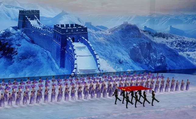 Members of the Chinese military march with a flag of China during the opening ceremony of the 9th Asian Winter Games in Harbin, China, Friday, Feb. 7, 2025. (Issei Kato/Pool Photo via AP)