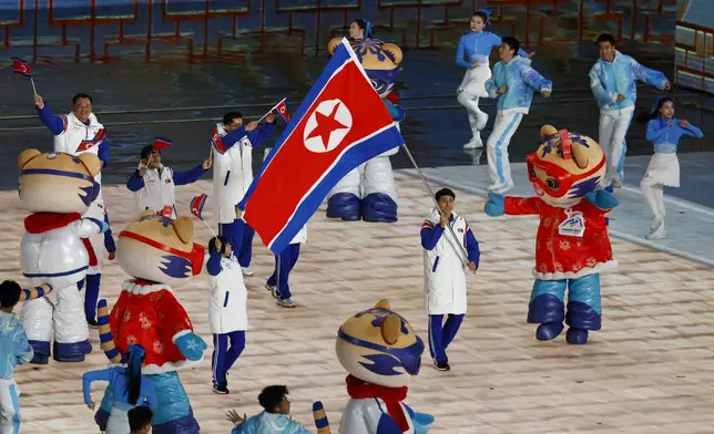North Korea's flag bearer leads their contingent during the parade of athletes at the opening ceremony of the 9th Asian Winter Games in Harbin, China, Friday, Feb. 7, 2025. (Issei Kato/Pool Photo via AP)