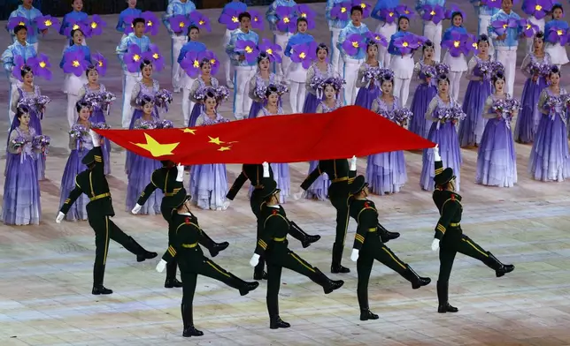 Members of the Chinese military march with a flag of China during the opening ceremony of the 9th Asian Winter Games in Harbin, China, Friday, Feb. 7, 2025. (Issei Kato/Pool Photo via AP)
