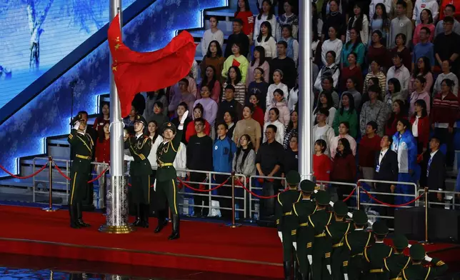 Members of the Chinese military raise a flag of China during the opening ceremony of the 9th Asian Winter Games in Harbin, China, Friday, Feb. 7, 2025. (Issei Kato/Pool Photo via AP)