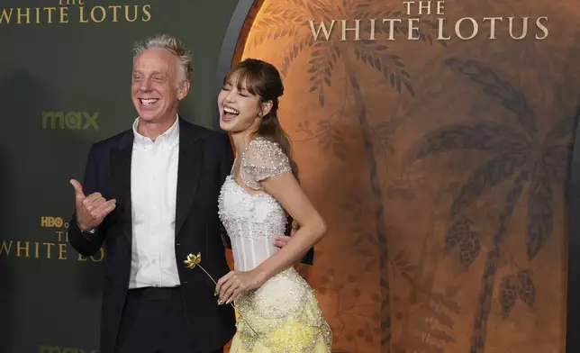 Mike White, left, makes the shaka hand gesture with Lisa at the season three premiere of "The White Lotus" on Monday, Feb. 10, 2025, at Paramount Theater in Los Angeles. (AP Photo/Chris Pizzello)