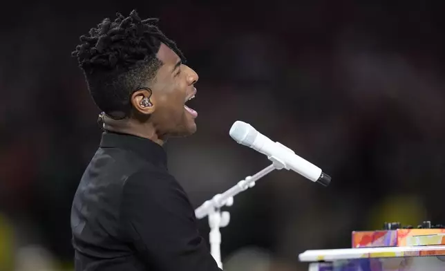 Jon Batiste performs the national anthem before the NFL Super Bowl 59 football game between the Kansas City Chiefs and the Philadelphia Eagles, Sunday, Feb. 9, 2025, in New Orleans. (AP Photo/Doug Benc)