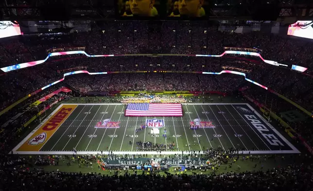 Jon Batiste performs the national anthem before the NFL Super Bowl 59 football game between the Kansas City Chiefs and the Philadelphia Eagles, Sunday, Feb. 9, 2025, in New Orleans. (AP Photo/David J. Phillip)