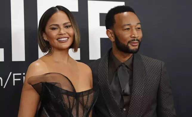 Chrissy Teigen, left, and John Legend arrive at the 67th annual Grammy Awards on Sunday, Feb. 2, 2025, in Los Angeles. (Photo by Jordan Strauss/Invision/AP)