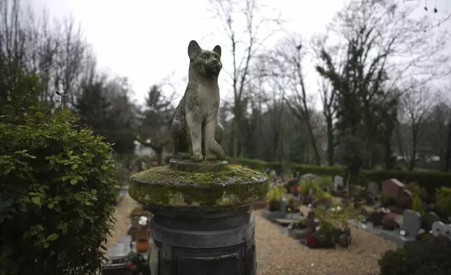 A sculpture of a cat is seen at the dog cemetery in AsniËres-sur-Seine, outside Paris, Tuesday, Feb. 25, 2025. (AP Photo/Christophe Ena)