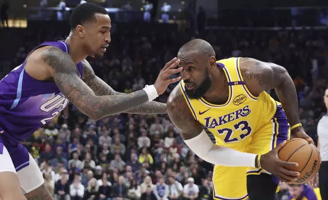Los Angeles Lakers forward LeBron James (23) looks to drive against Utah Jazz forward John Collins (20) during the first half of an NBA basketball game, Wednesday, Feb. 12, 2025, in Salt Lake City. (AP Photo/Rob Gray)