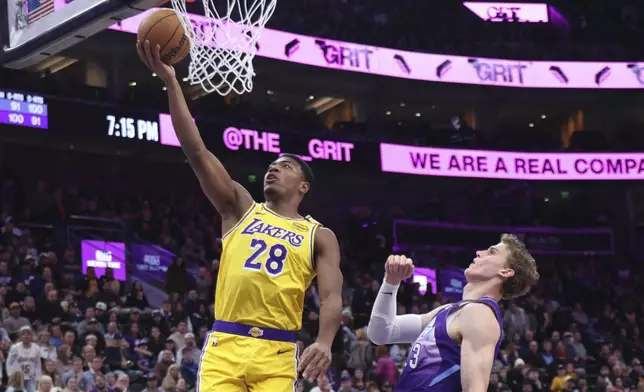 Los Angeles Lakers forward Rui Hachimura (28) lays the ball up against Utah Jazz forward Lauri Markkanen (23) during the first quarter of an NBA basketball game, Wednesday, Feb. 12, 2025, in Salt Lake City. (AP Photo/Rob Gray)