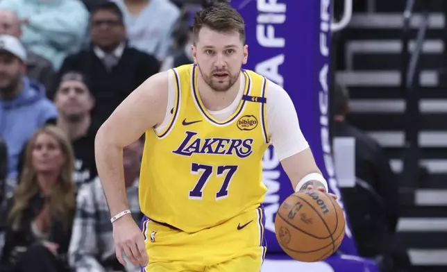 Los Angeles Lakers guard Luka Doncic brings the ball up the court against the Utah Jazz during the first half of an NBA basketball game, Wednesday, Feb. 12, 2025, in Salt Lake City. (AP Photo/Rob Gray)