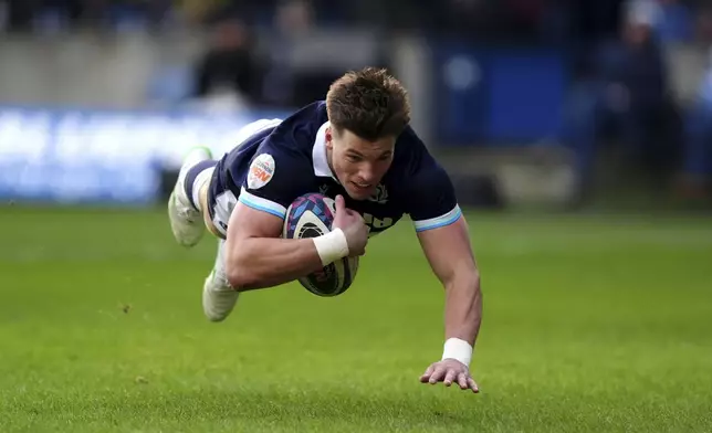 Scotland's Huw Jones scores a try during the Six Nations rugby union match between Scotland and Italy, at Murrayfield Stadium, Edinburgh, Scotland, Saturday Feb. 1, 2025. (Andrew Milligan/PA via AP)