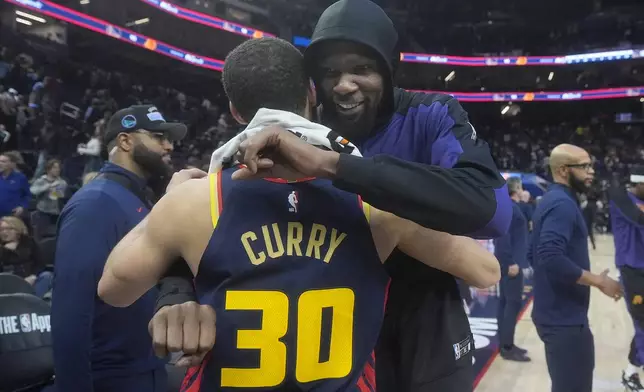 Golden State Warriors guard Stephen Curry (30) hugs Phoenix Suns forward Kevin Durant after an NBA basketball game in San Francisco, Friday, Jan. 31, 2025. (AP Photo/Jeff Chiu)