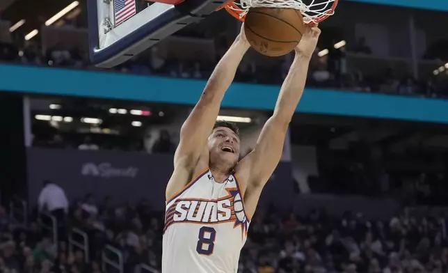 Phoenix Suns guard Grayson Allen (8) dunks against the Golden State Warriors during the first half of an NBA basketball game in San Francisco, Friday, Jan. 31, 2025. (AP Photo/Jeff Chiu)