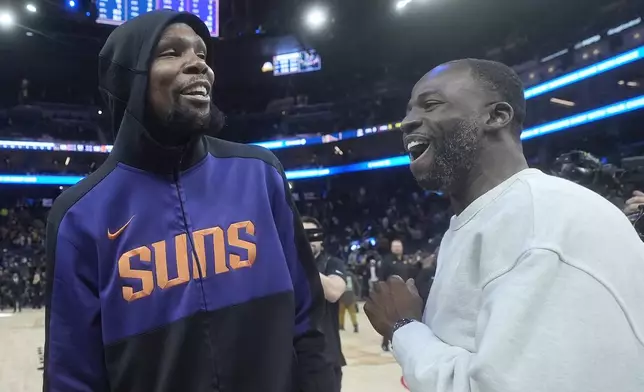Phoenix Suns forward Kevin Durant, left, talks with Golden State Warriors forward Draymond Green after an NBA basketball game in San Francisco, Friday, Jan. 31, 2025. (AP Photo/Jeff Chiu)