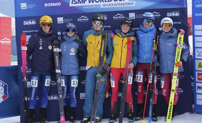 First placed Spain's Ana Alonso Rodriguez and Oriol Cardona Coll, centre, smile on the podium with second placed France's Emily Harrop and Thibault Anselmet, left, and third placed Switzerland's Marianne Fatton and Robin Bussard, during the mixed relay race at the Ski Mountaineering World Cup event in Bormio, Italy, Sunday, Feb. 23, 2025. (AP Photo/Antonio Calanni)