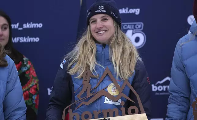 France's Emily Harrop smiles after winning the women's sprint race at the Ski Mountaineering World Cup event in Bormio, Italy, Saturday, Feb. 22, 2025. (AP Photo/Antonio Calanni)