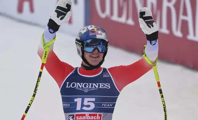 Switzerland's Franjo von Allmen celebrates at the finish area of a downhill run of a men's team combined event, at the Alpine Ski World Championships, in Saalbach-Hinterglemm, Austria, Wednesday, Feb. 12, 2025. (AP Photo/Giovanni Auletta)