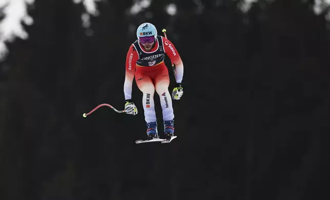 Switzerland's Alexis Monney competes in a downhill run of a men's team combined event, at the Alpine Ski World Championships, in Saalbach-Hinterglemm, Austria, Wednesday, Feb. 12, 2025. (AP Photo/Marco Trovati)