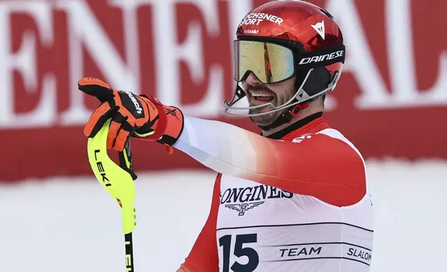 Switzerland's Loic Meillard celebrates at the finish area of a slalom run of a men's team combined event, at the Alpine Ski World Championships, in Saalbach-Hinterglemm, Austria, Wednesday, Feb. 12, 2025. (AP Photo/Marco Trovati)