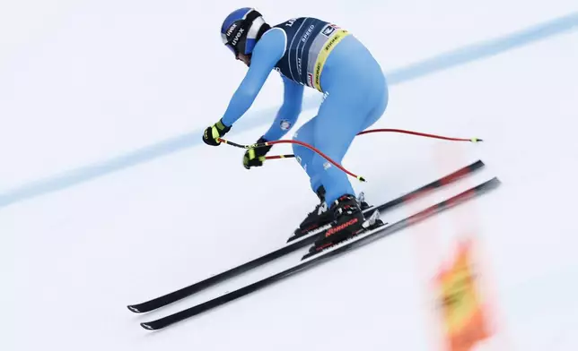 Italy's Dominik Paris competes in a downhill run of a men's team combined event, at the Alpine Ski World Championships, in Saalbach-Hinterglemm, Austria, Wednesday, Feb. 12, 2025. (AP Photo/Gabriele Facciotti)