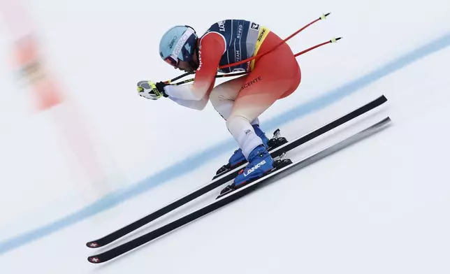 Switzerland's Alexis Monney competes in a downhill run of a men's team combined event, at the Alpine Ski World Championships, in Saalbach-Hinterglemm, Austria, Wednesday, Feb. 12, 2025. (AP Photo/Gabriele Facciotti)