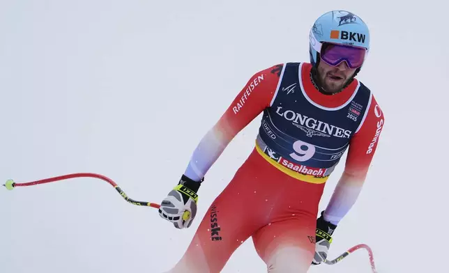 Switzerland's Alexis Monney at the finish area of a downhill run of a men's team combined event, at the Alpine Ski World Championships, in Saalbach-Hinterglemm, Austria, Wednesday, Feb. 12, 2025. (AP Photo/Giovanni Auletta)