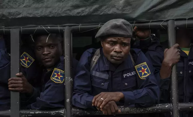Former members of the Armed Forces of the Democratic Republic of Congo (FARDC) and police officers who allegedly surrendered to M23 rebels arrive in Goma, Congo, Sunday, Feb. 23, 2025. (AP Photo/Moses Sawasawa)
